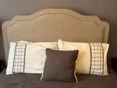 Used only a handful of times, this bed frame, upholstered headboard and sideboards, and Queen mattre...