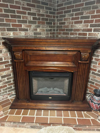 Electric fireplace with wood mantle surround