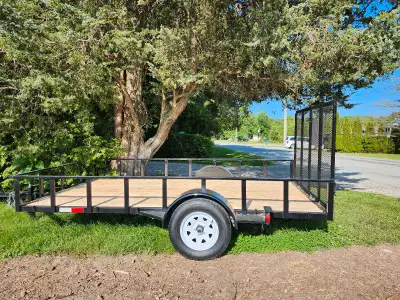 This trailer has a solid frame and a wooden bed. It's in new condition and ready for your next proje...