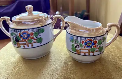 Vintage lustreware sugar and creamer set, perfect for adding a touch of old-world elegance to your t...