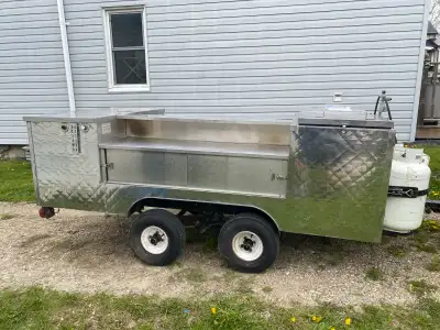 One of a kind double axle bbq trailer. Stainless steel construction, refrigerator, 3 compartment sin...
