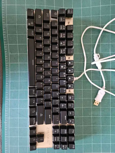 This is a used ZHUQUE mechanical keyboard with blue switches, perfect for gaming or programming. The...