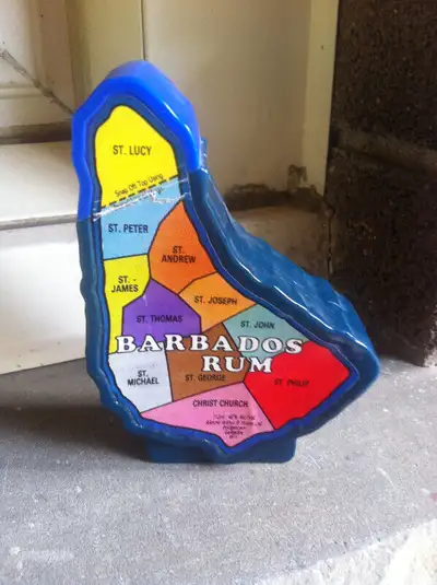 This is a Barbados Rum mini plastic liqueur bottle standing approx. 4.25 inches tall.