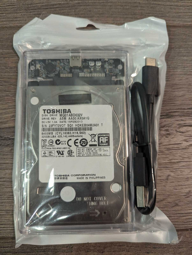NIP - Toshiba 320GB HARD DRIVE in External Case with Cable in Laptop Accessories in Oshawa / Durham Region