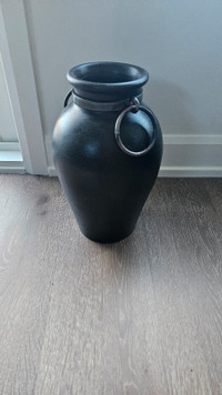 Pottery vase with metal rings 