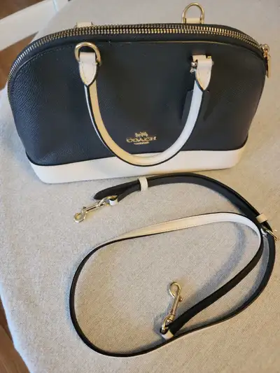 Genuine Coach bag. Bag can be used as handheld or crossbody style. Metal feet at bottom of bag. 2 po...