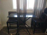 Bar height table and two chairs.