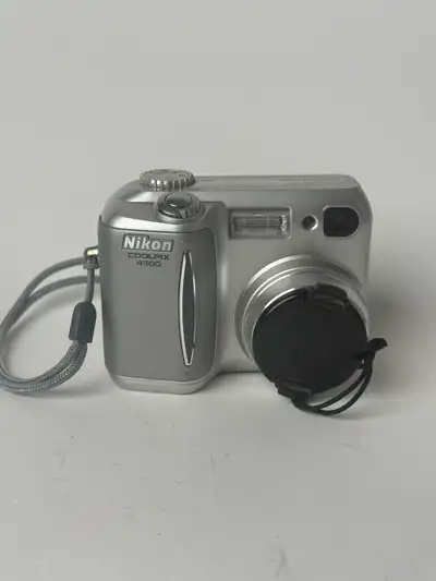 This is a used Nikon Coolpix 4300 digital camera, perfect for capturing memories with its 4.0 MP res...