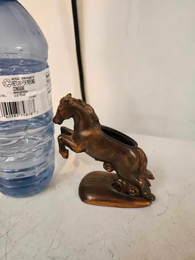 This striking horse statue captures the essence of equestrian grace and power, crafted with a keen e...