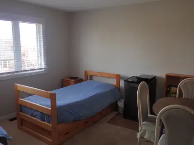 A large, bright, second-floor, pet-friendly bedroom with a backyard view is available for one person...