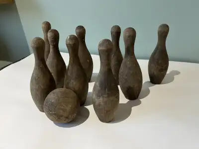 This is a vintage wooden carnival game. You wouldn't have to knock all the pins over with the small...