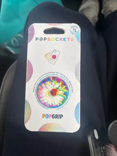 New, unopened Rainbow flower pop socket for cell phone Pops out and goes on the back of your phone,...