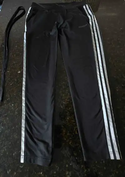 Black Adidas 3 side stripe pants, size small in women. In good used condition, however the drawstrin...