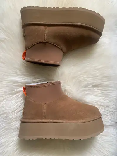 Step into style with these Ugg Mini Platform boots, brand new in the box and ready to elevate your f...