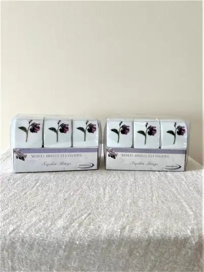 Set of 6 new in box napkin ring holders-never used--2 boxes Ceramic with a beautiful Irish flower de...