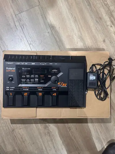 Selling a vintage Roland GR-33 guitar synthesizer in used condition, but still packs a punch with it...