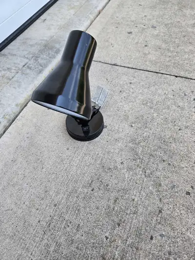 Illuminate your workspace with this sleek, black Ikea lamp, perfect for desks or bedside tables, fea...