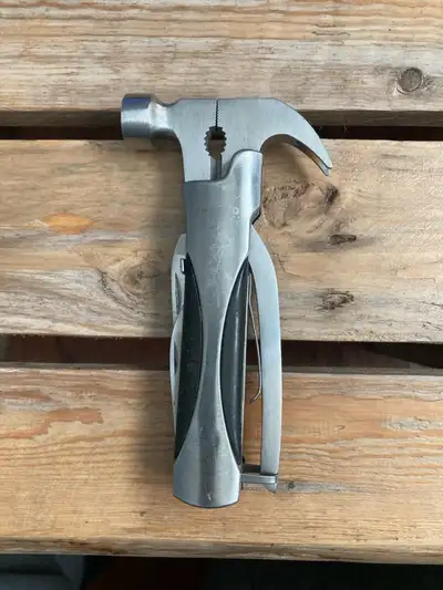 Hand held multi tool with a hammer and claw.