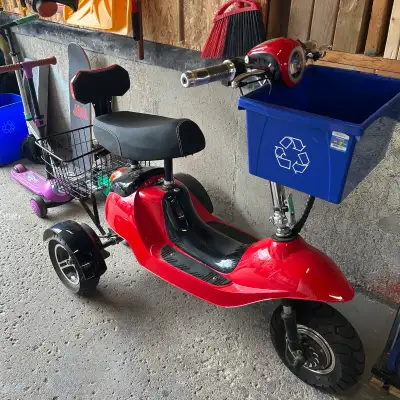 This red 3-wheel scooter is perfect for getting around town! It's in used condition and has a basket...