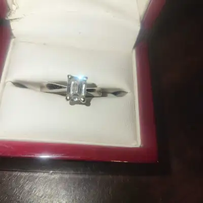 Real diamonds. Emerald cut, white gold, solitaire engagement ring - think it's about a karat. White...