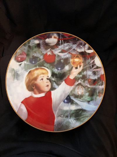 "Erik's Delight" is the third plate in the Children at Christmas collection. Painted by Donald Zolan...