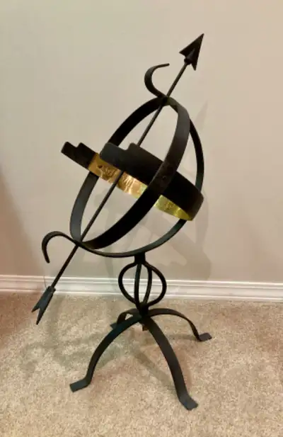 Decorative brass and black metal sundial. $25