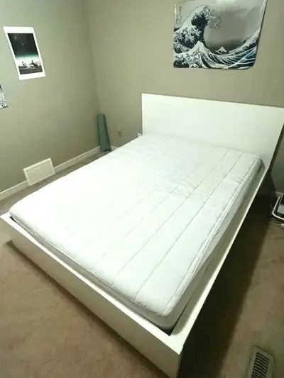 This is an IKEA queen bed frame and mattress with two large drawers that can be moved to either side...