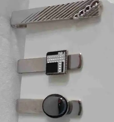 Elevate your style with this set of three assorted tie clips, perfect for adding a touch of sophisti...