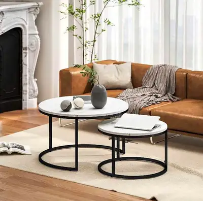 Add a modern touch to your living space with this set of nesting coffee tables, featuring a sleek wh...