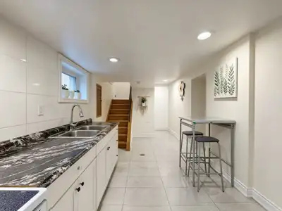 Furnished basement suite (1 bedroom + very large living room) with private separate entrance in a qu...