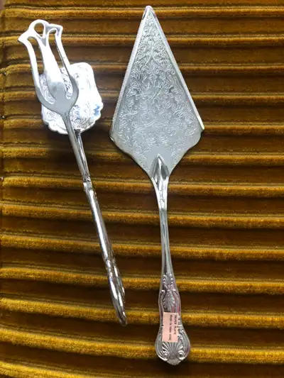Selling a set of two serving items: a cake server and a cake tong. They are silverplated, ep zinc si...
