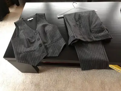 Women’s pinstripe suit set. Includes a vest and trousers. Dark grey with thin white pinstripes. Clas...