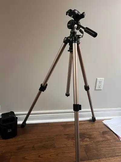 Velbon aluminum tripod with a pan/tilt head, suitable for cameras, camcorders, or lightweight setups...