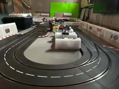 Custom layout and base 12 assorted 1/32 scale cars with cases Pit lane, 3 lane change sections 4 Wir...