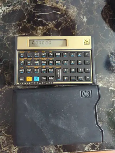 This is a used Hewlett-Packard HP-12C financial calculator, a reliable tool for financial calculatio...
