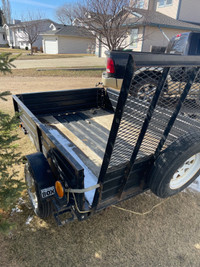 Small utility trailer with ramp and dump feature 