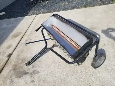 Tow behind Drop Spreader and Aerator. Used but in good condition.