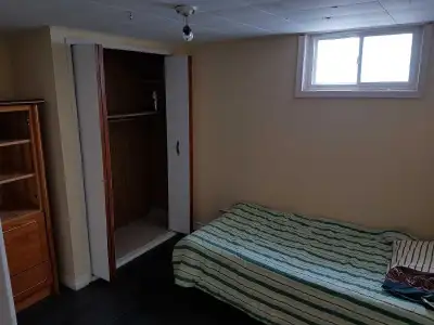 This functional room for rent offers a convenient living space featuring a bed, ample closet storage...