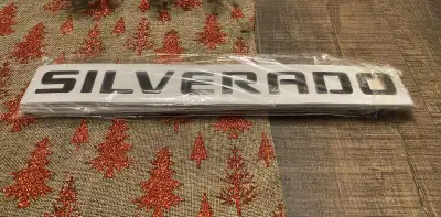 a set of black 3D "Silverado" emblems designed for Chevrolet Silverado trucks. These are accessories...