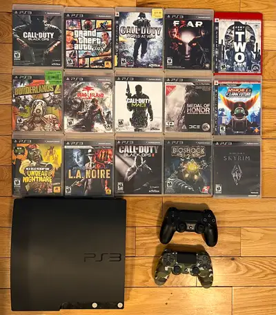 Selling a PS3 Slim with 2 DualShock controllers and 15 popular games. Everything works great — perfe...