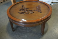 ROUND COFFEE TABLE WITH A CARVED TREE DECORATION