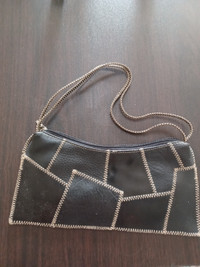 Black designer handbag with zig-zag stitches leather