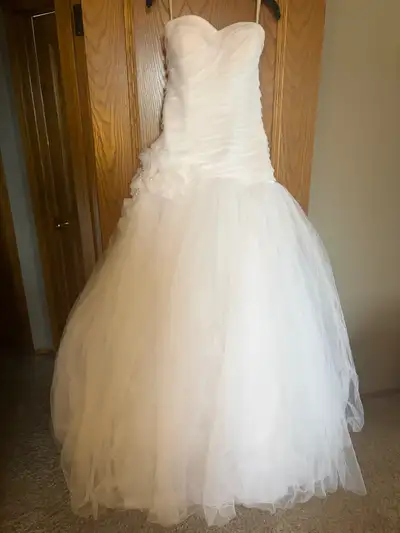 Size 10 wedding dress with alterations. Has not been dry cleaned since wedding, so would require dry...