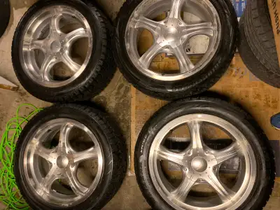 Polished silver rims multi bolt pattern, the 4 tires are 225/50/18”, 3x Blizzak 1x Hankook, Hankook...