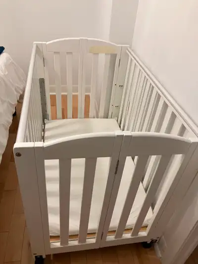 2 in 1 Folding Stationary Crib, white Two position folding crib, Mattress Pad Included Simply fold f...