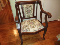 Antique parlor chair with saber style legs, wood and upholstery
