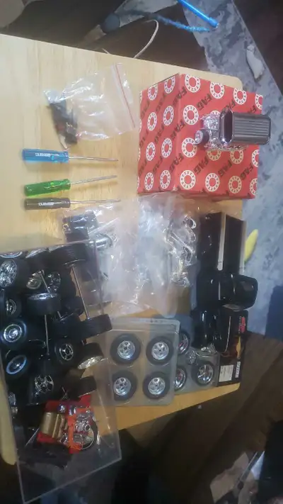 Assortment of model car parts.The green box is in its original plastic wrap. The 2 sets of tires are...