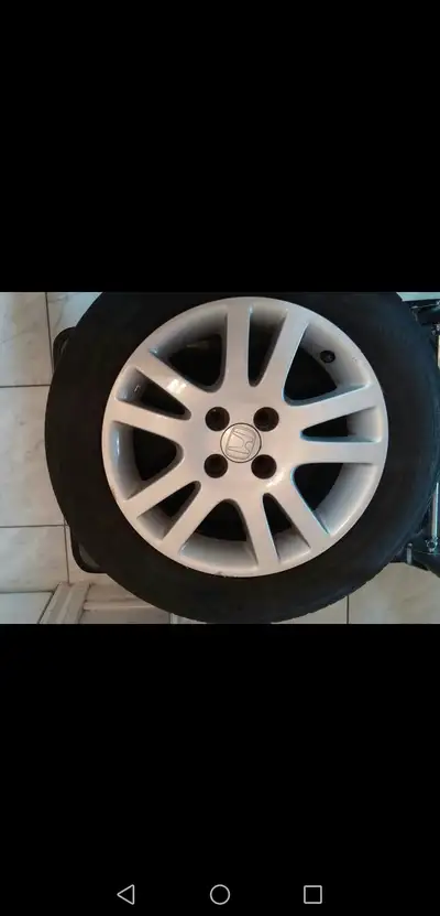 This is 4 tires. It's silver with a 5-spoke design. It includes the tire.The tires is worn out and n...