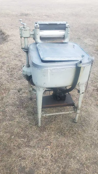 This vintage Maytag wringer washing machine is a classic piece of appliance history, perfect for col...