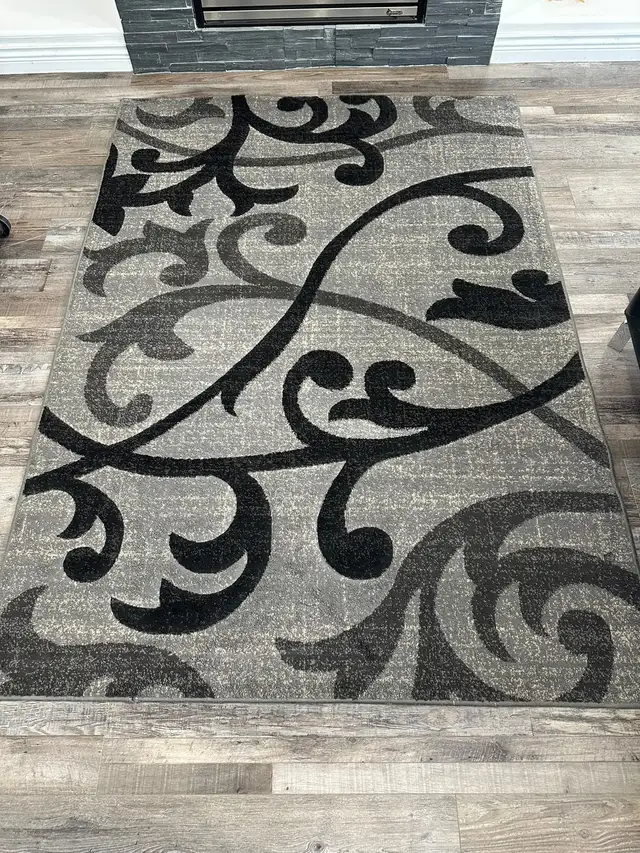 Black and grey floral pattern area rug